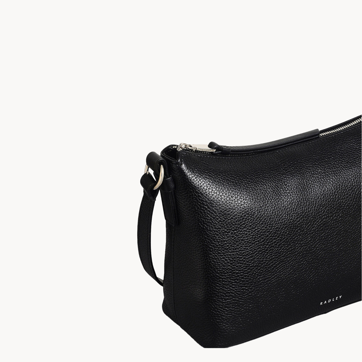 Black leather handbag with a strap on a white background