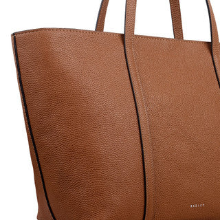 Close-up of a brown leather tote bag with visible brand name.