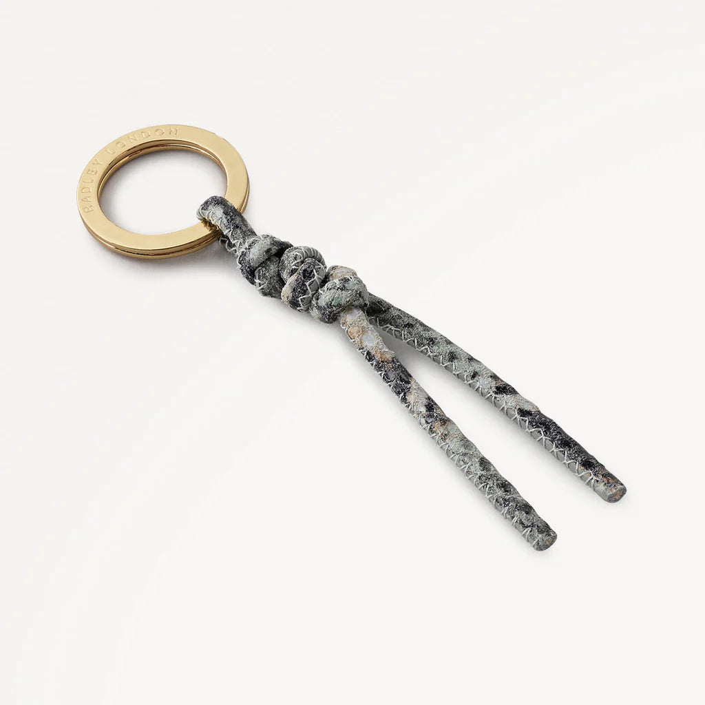 Keychain with marble pattern and gold ring on a white background