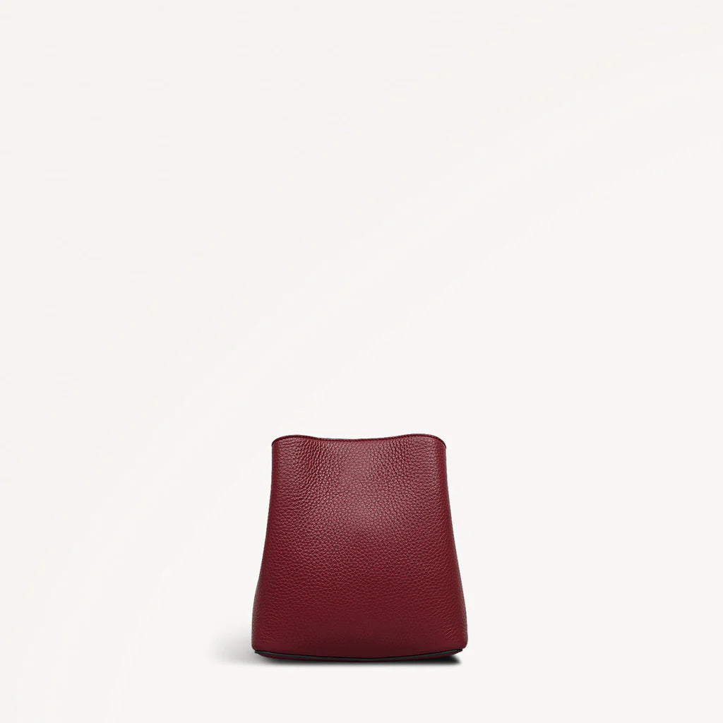 Red leather handbag on a white background