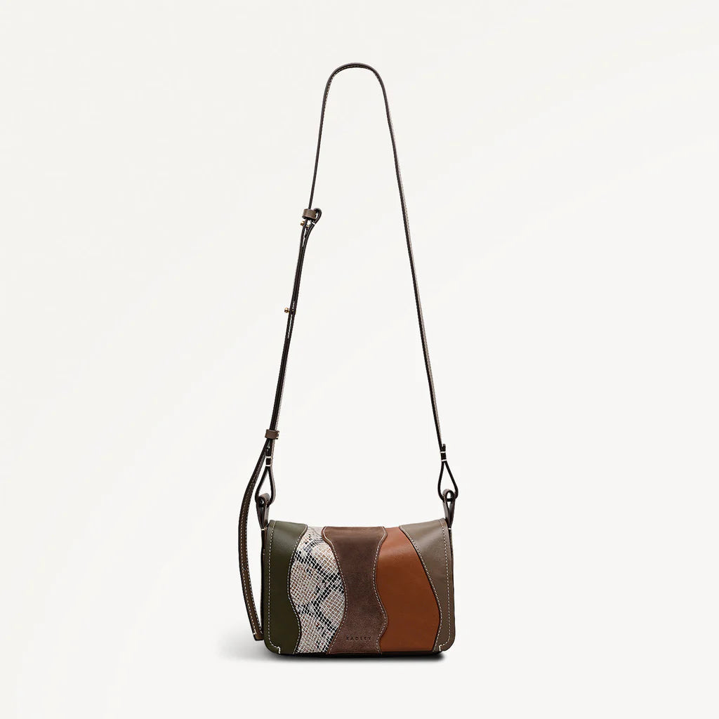 Multicolored handbag with a strap on a light gray background