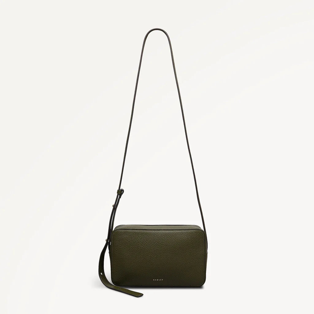 Green crossbody bag with a strap on a light gray background