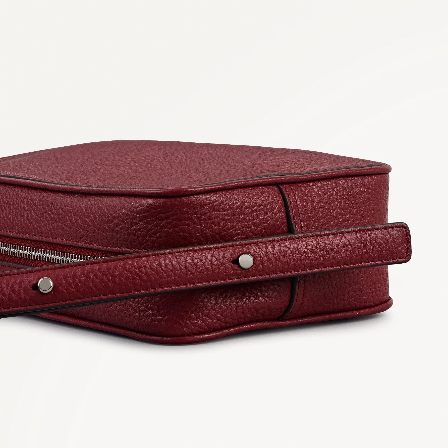 Red leather bag with a handle on a white background