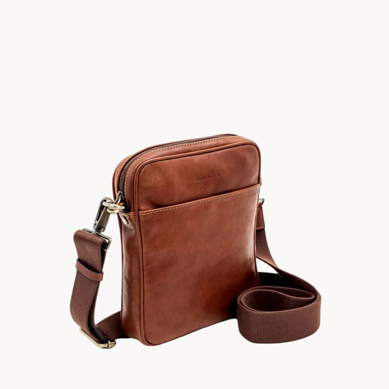 Brown leather crossbody bag on a white background