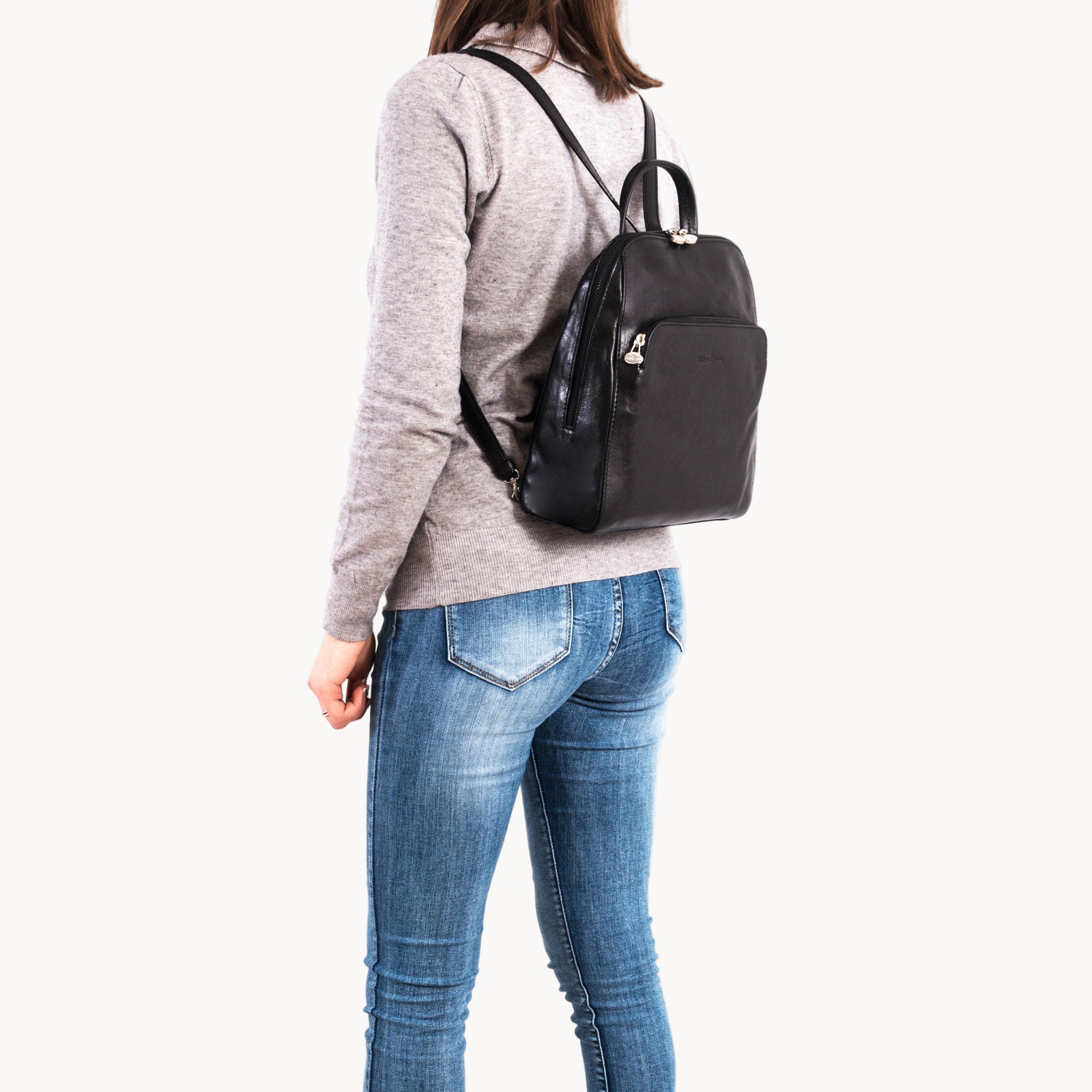 Person wearing a black backpack on a white background