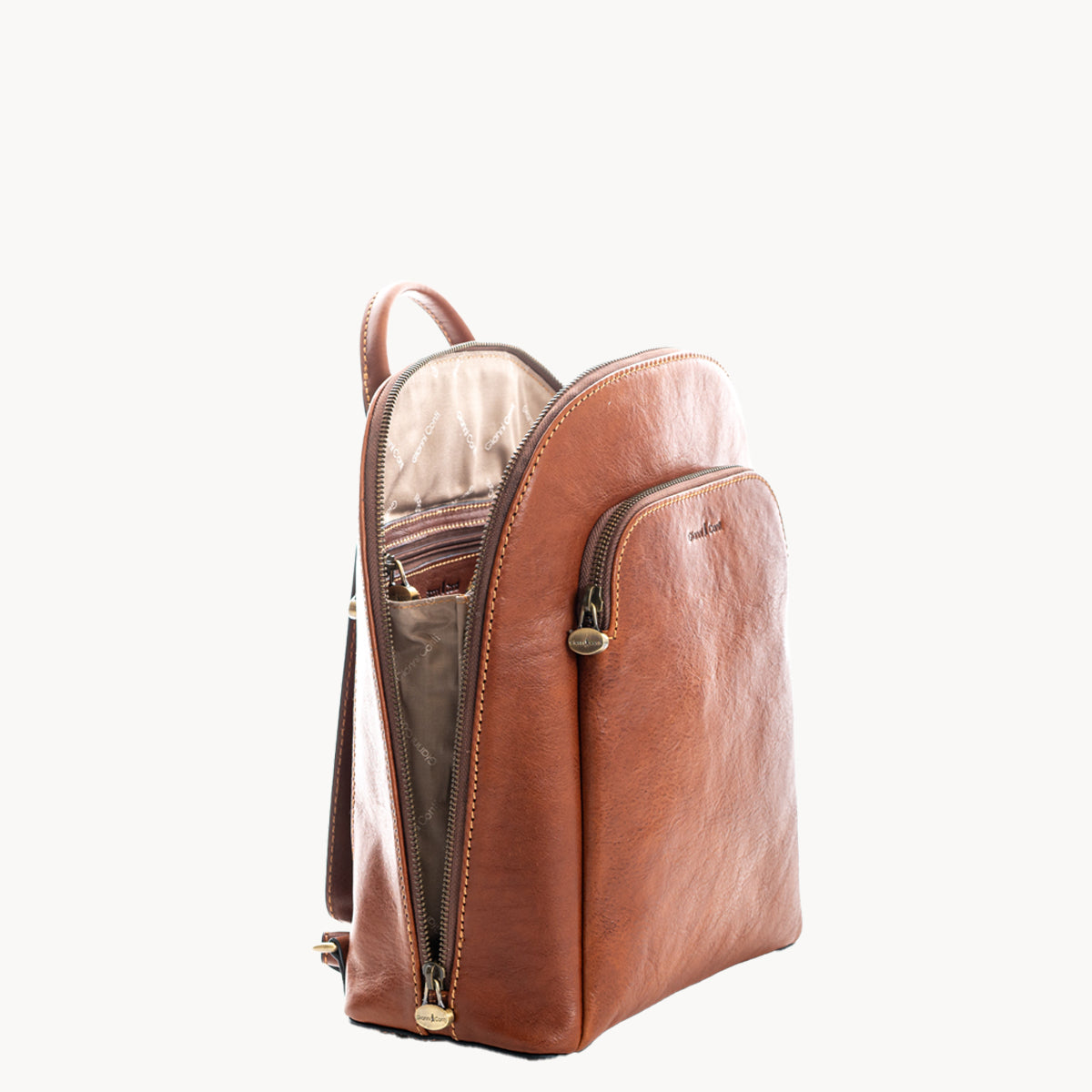Tan leather backpack with gold zippers on a white background