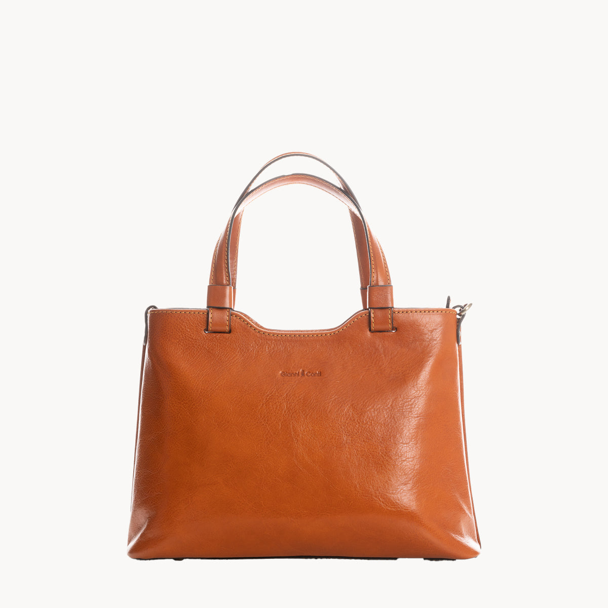 Tan leather handbag on a white background