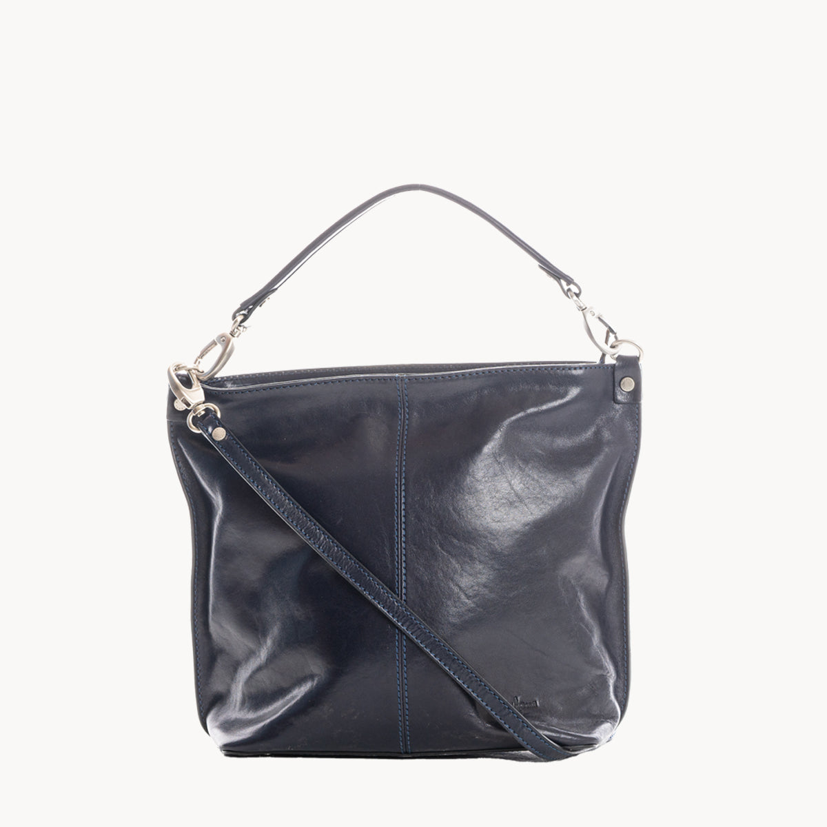 Blue leather handbag with a shoulder strap on a white background