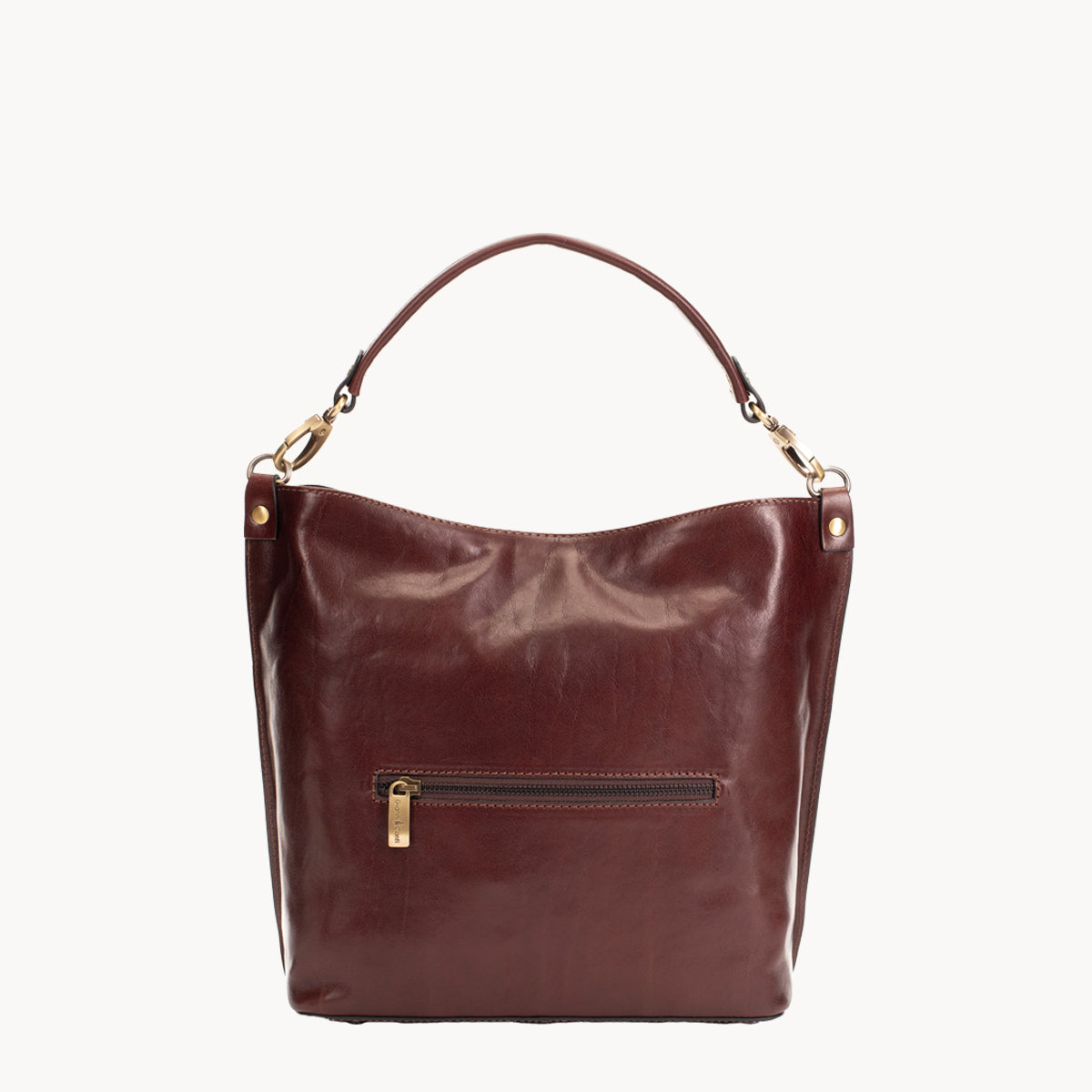 Brown leather handbag with gold accents on a white background