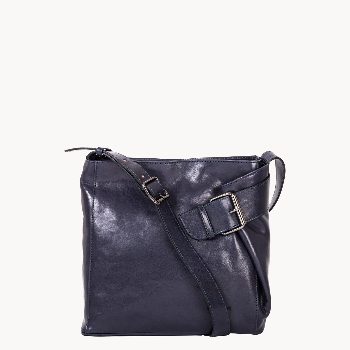 Dark blue leather handbag with a shoulder strap on a white background