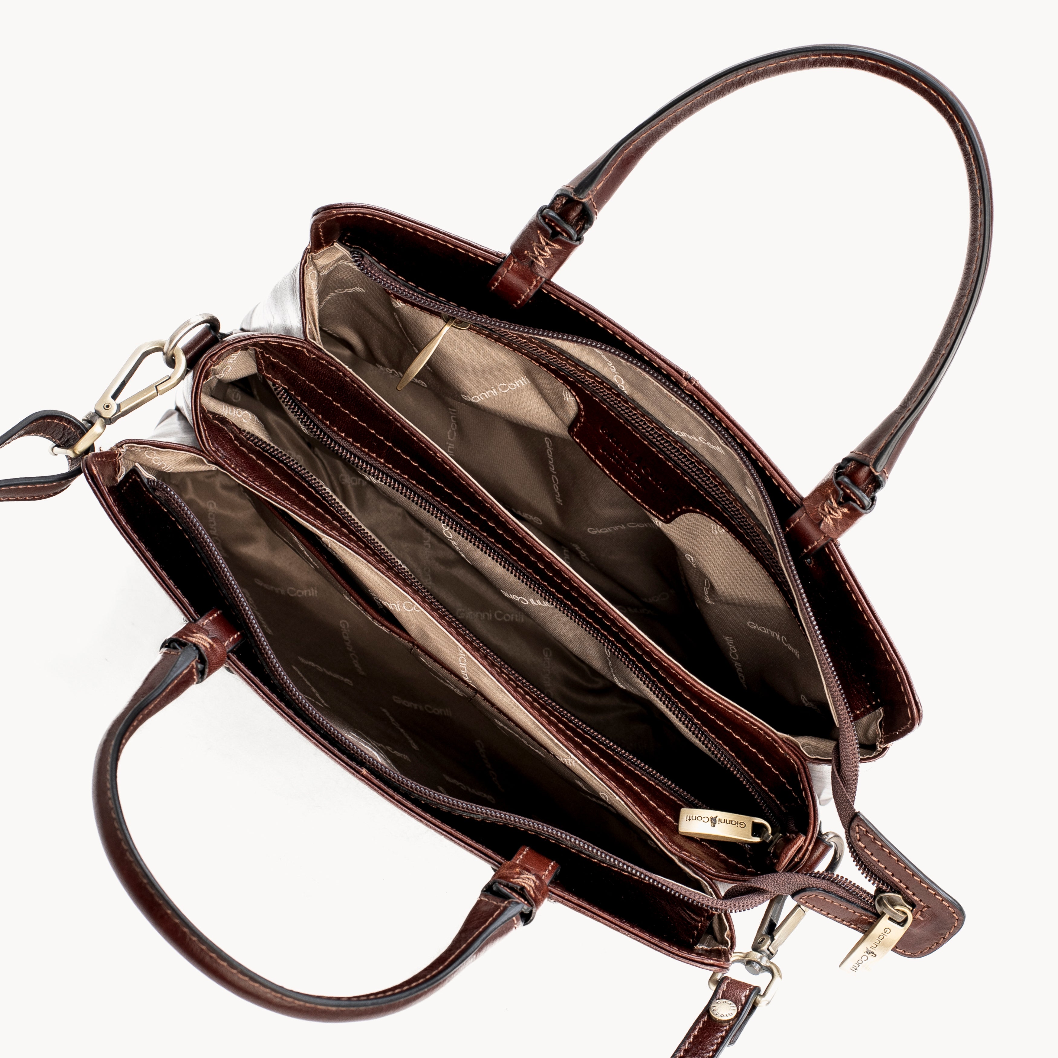 Brown leather handbag with open interior on a white background