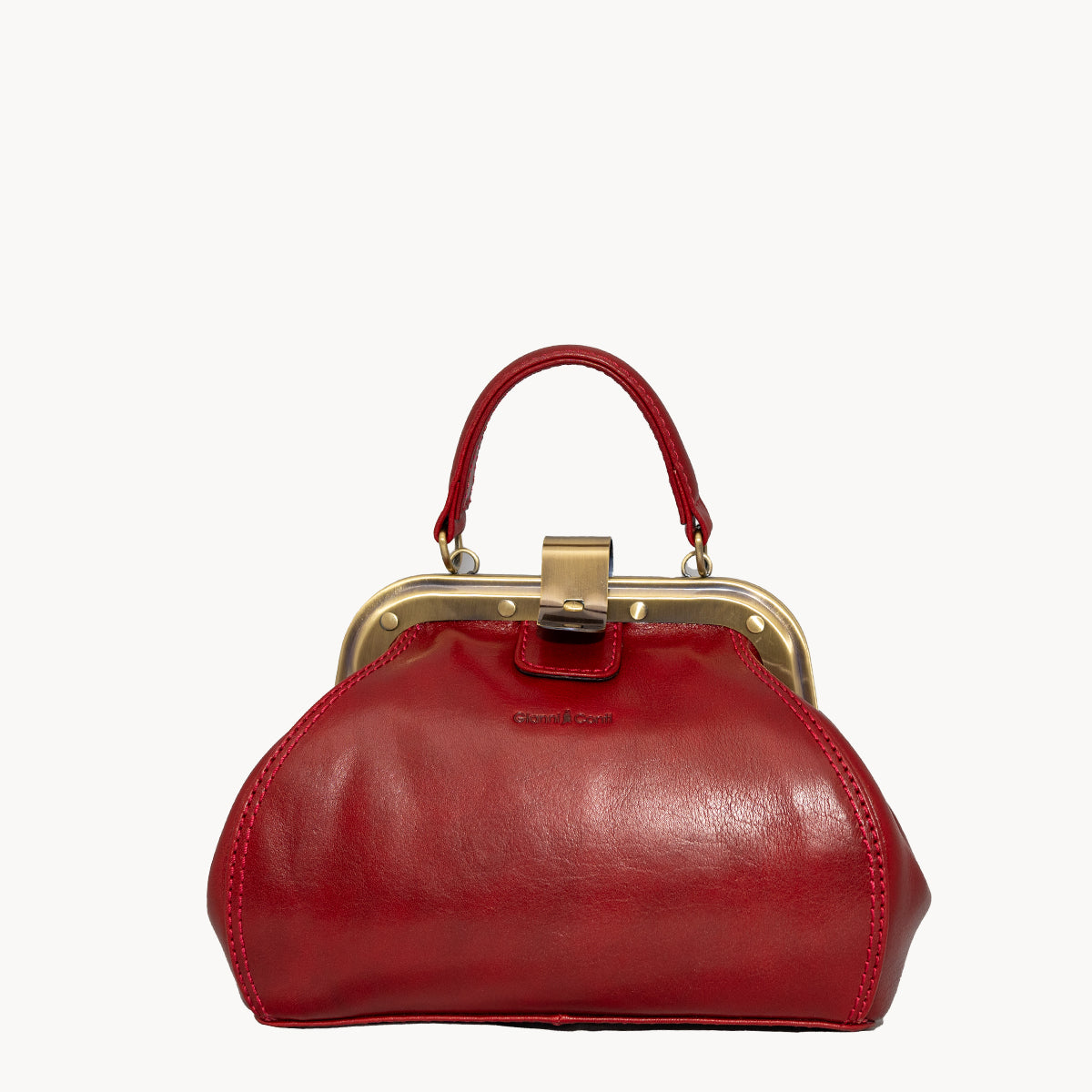 Red Gladstone style bag with metal clip opening and grad handle with detachable long strap.