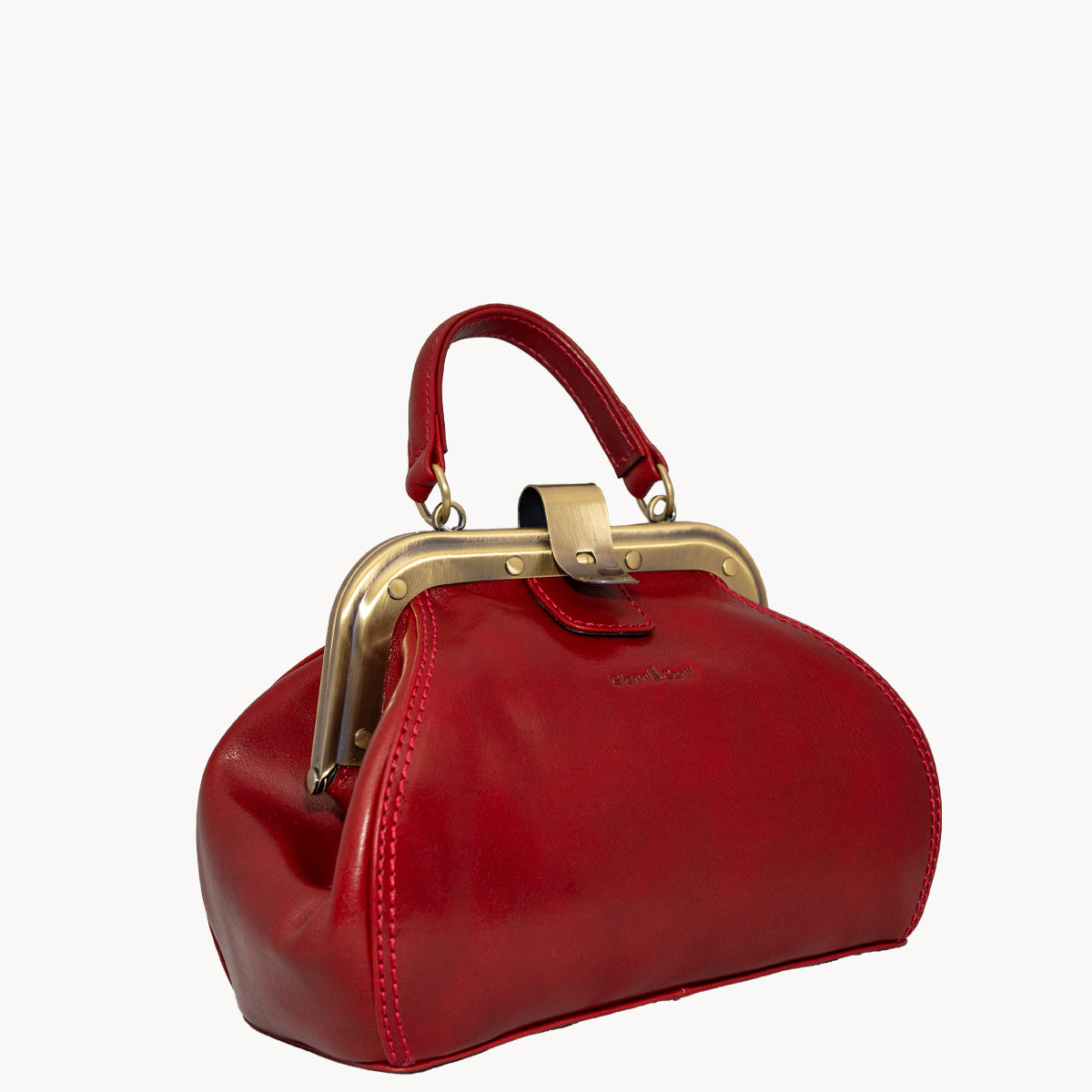 Red Gladstone style bag with metal clip opening and grad handle with detachable long strap.
