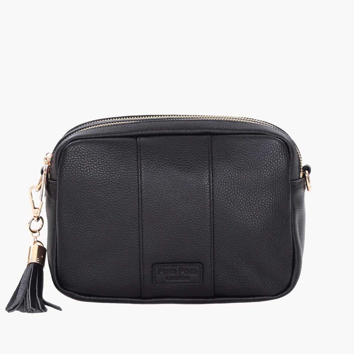Black leather crossbody bag with a tassel on a white background