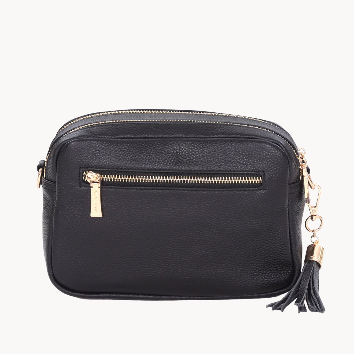 Black leather crossbody bag with gold zipper and tassel on a white background