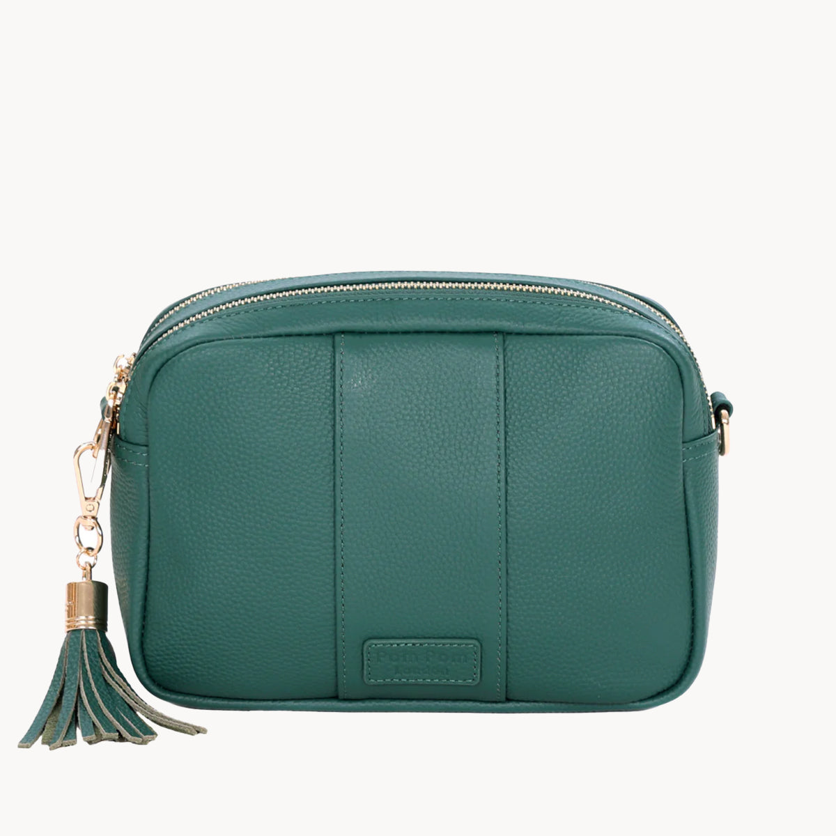 Green handbag with a tassel on a white background