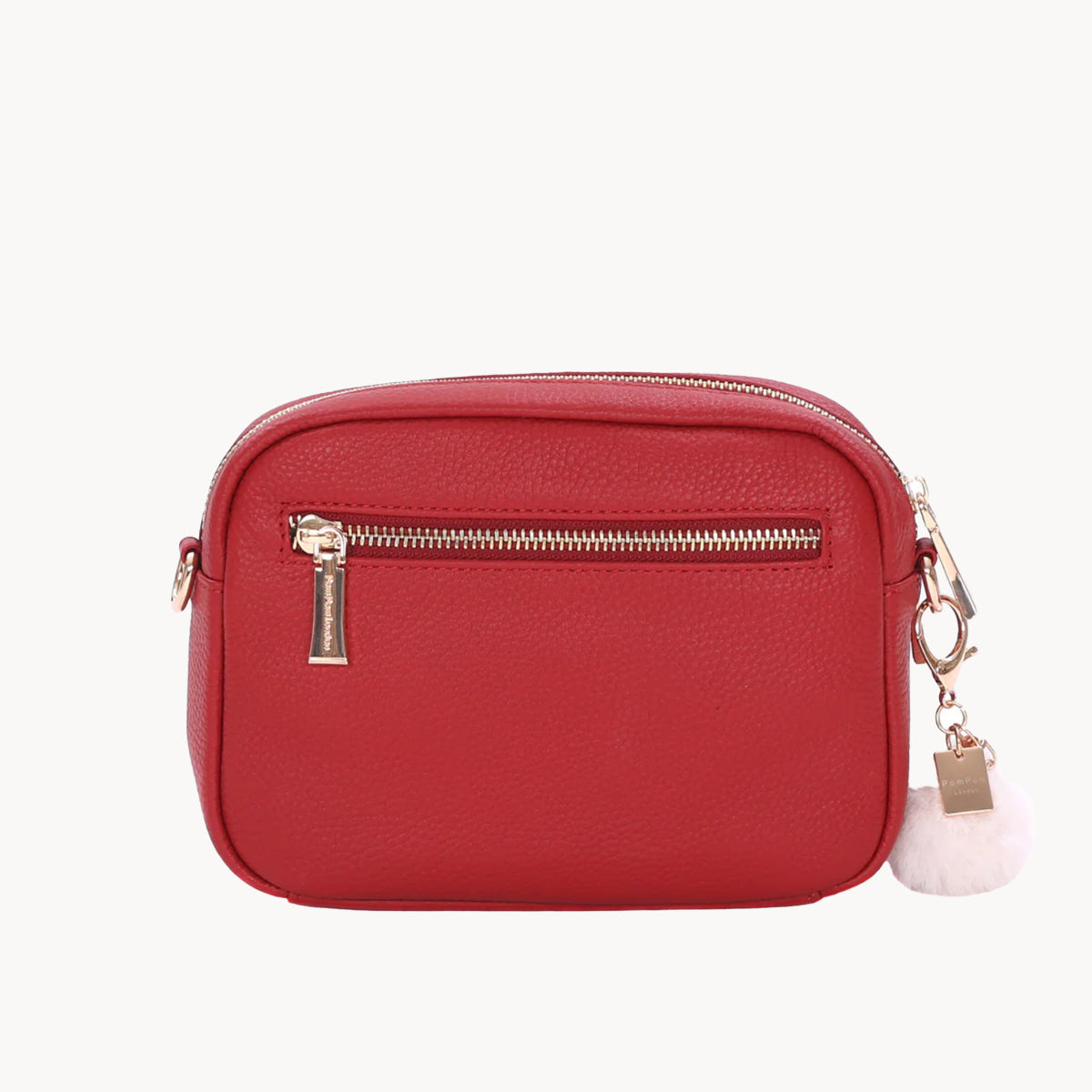 Red handbag with gold zipper and white tag on a white background