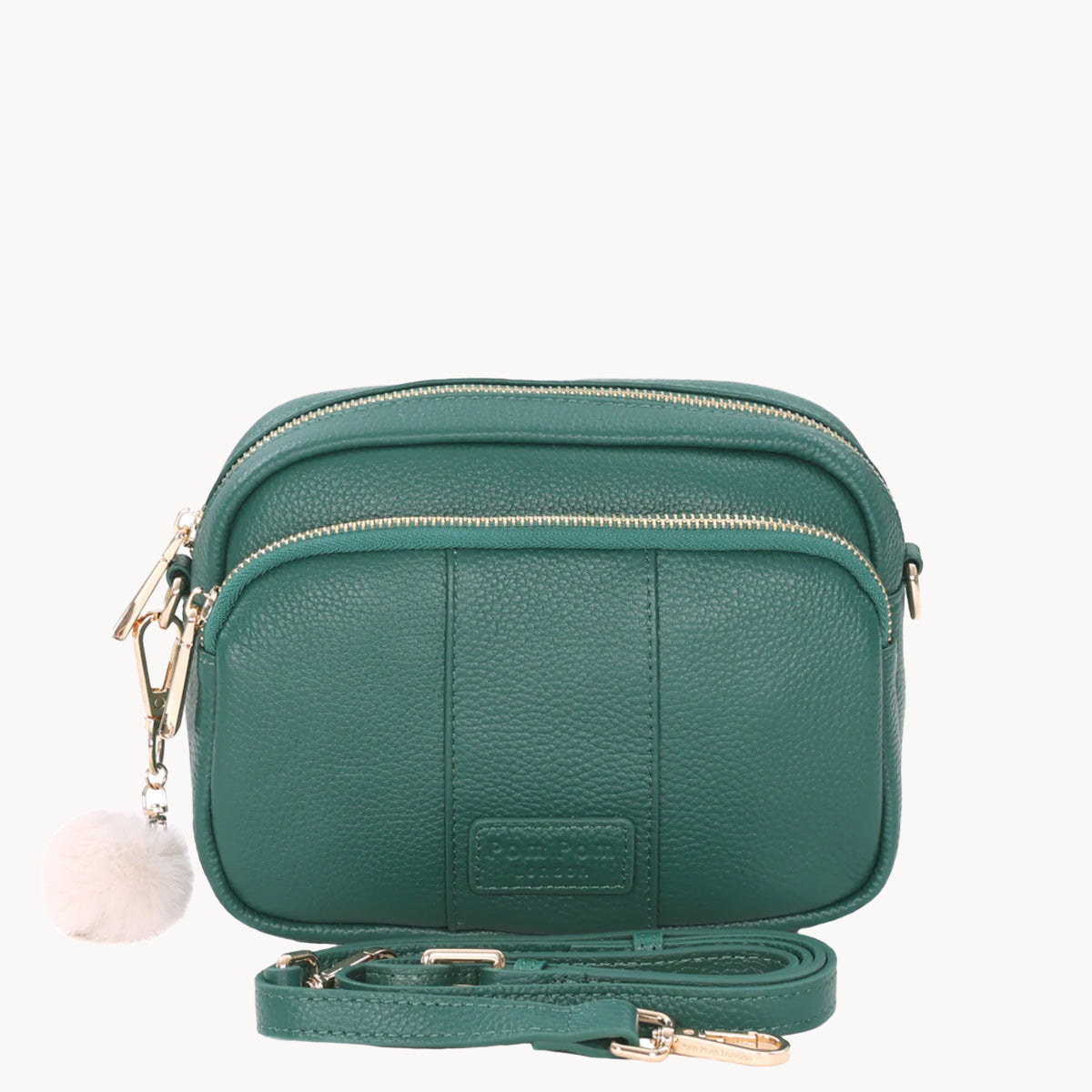 Green leather crossbody bag with a visible brand logo on a white background