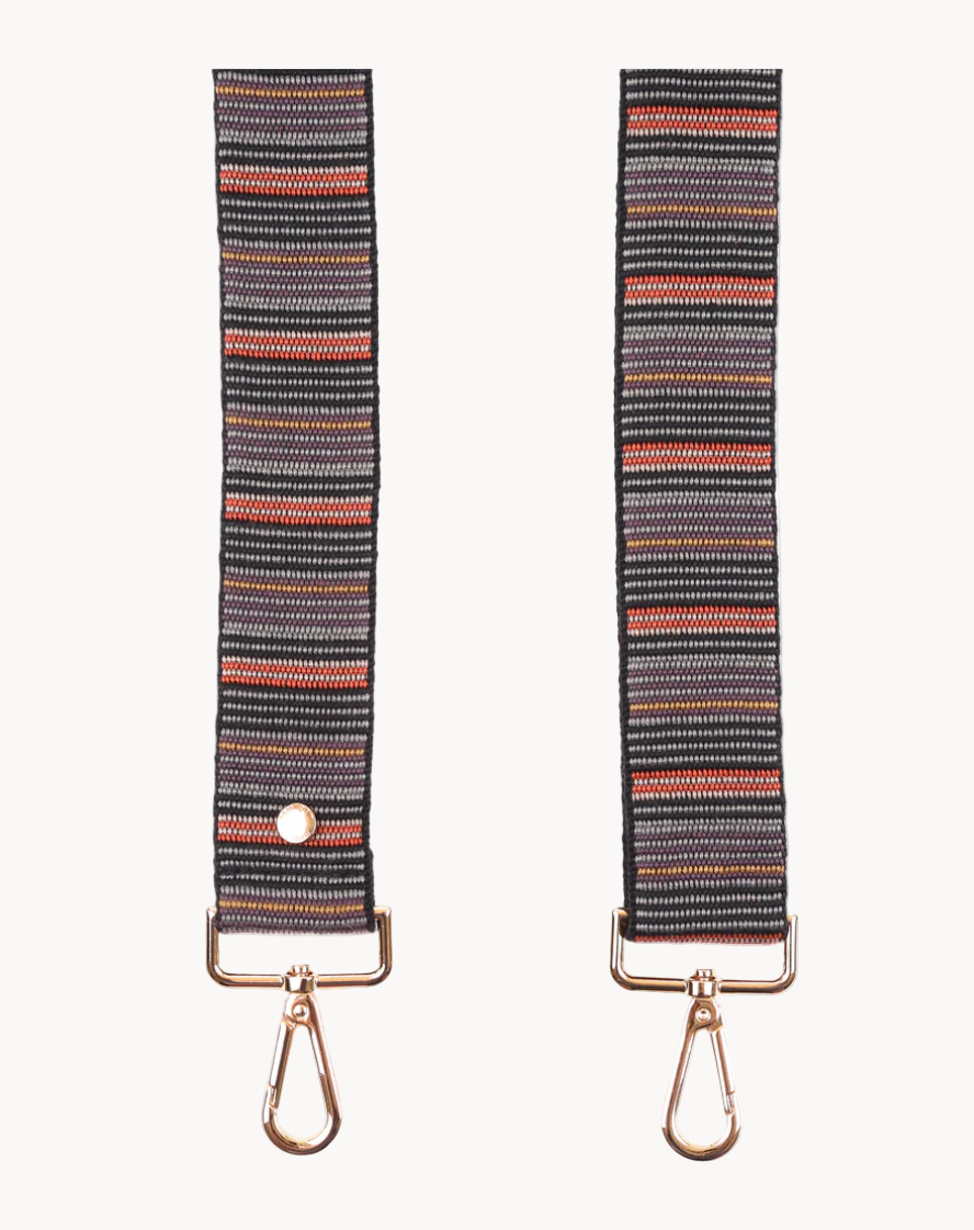 Striped fabric bag strap with metal hooks on a white background