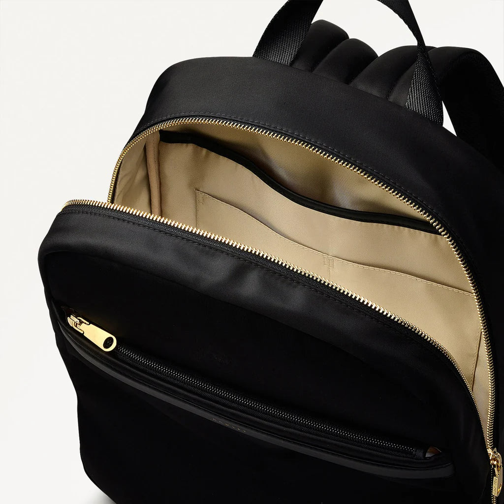 Black backpack with open front compartment showing beige interior.