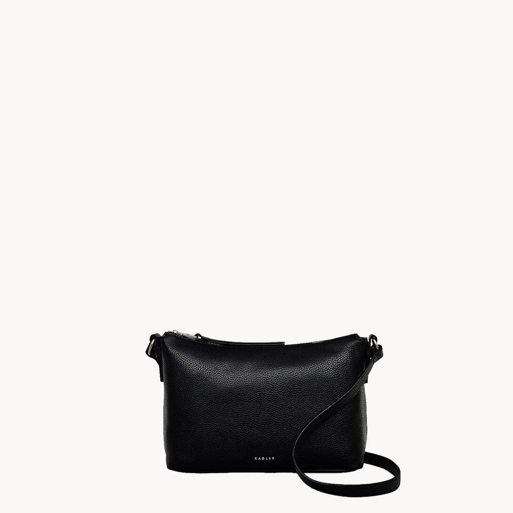 Black handbag with a strap on a white background