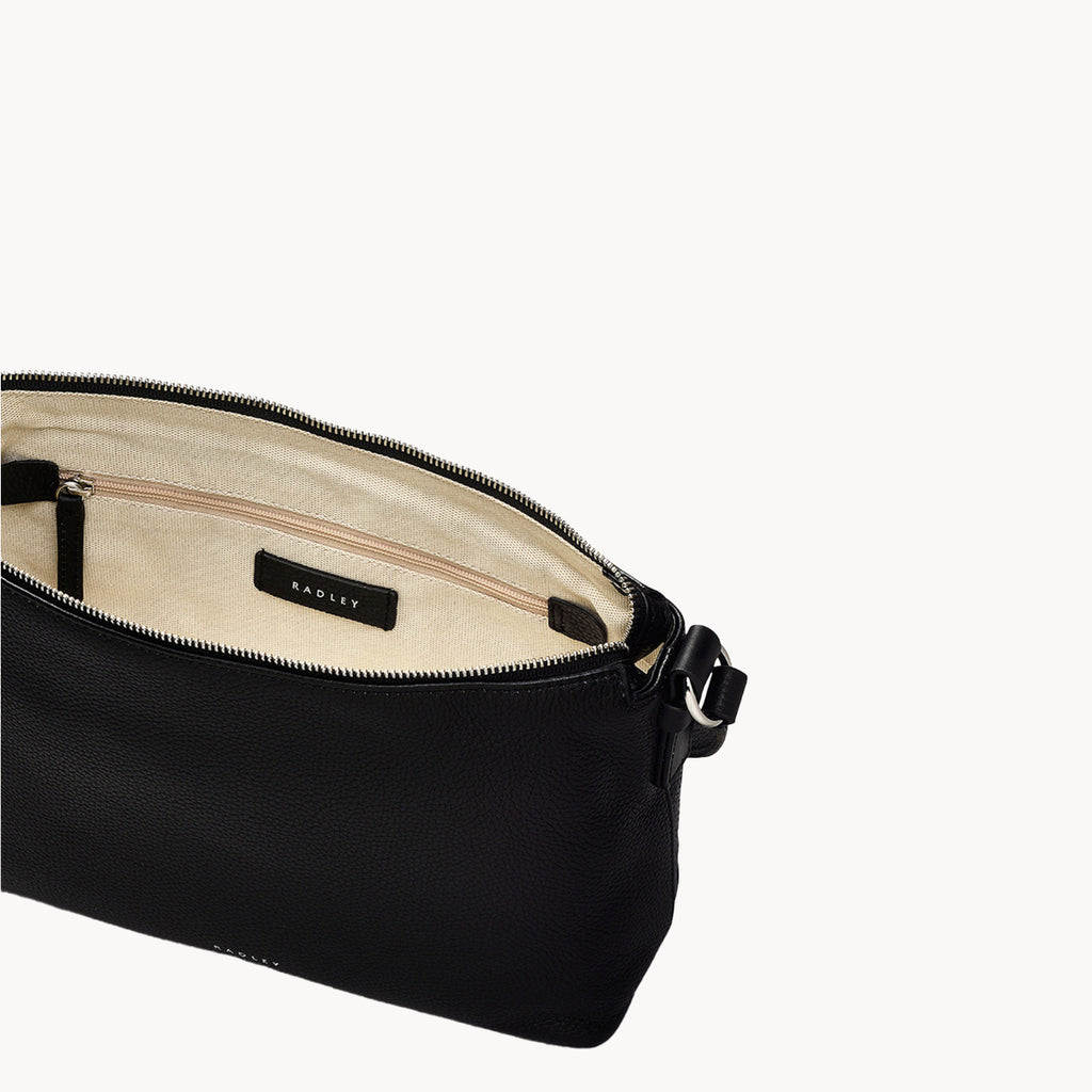 Black leather bag with beige interior on a white background