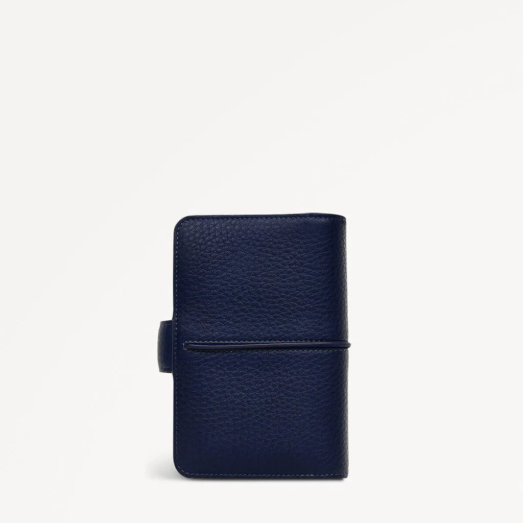 Navy blue leather wallet on a light gray background