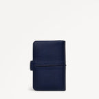 Navy blue leather wallet on a light gray background