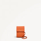Orange leather crossbody bag on a white background
