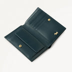 Teal leather wallet with gold accents on a white background