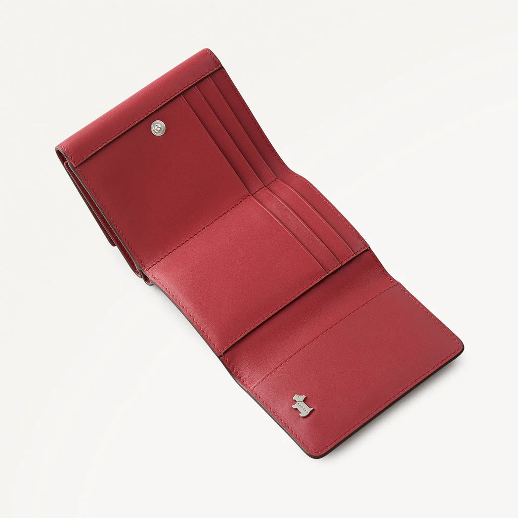 Red leather wallet on a light gray background