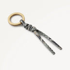 Keychain with marble pattern and gold ring on a white background