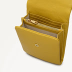 Yellow leather wallet with a gold zipper on a white background