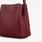 Red handbag with 'Radley' branding on a light gray background