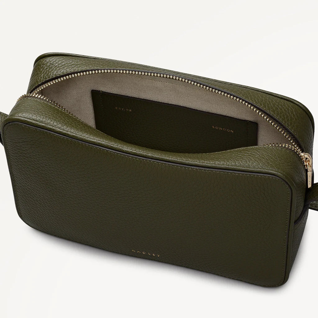 Green leather bag with a black interior on a white background