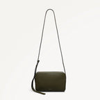 Green crossbody bag with a strap on a light gray background