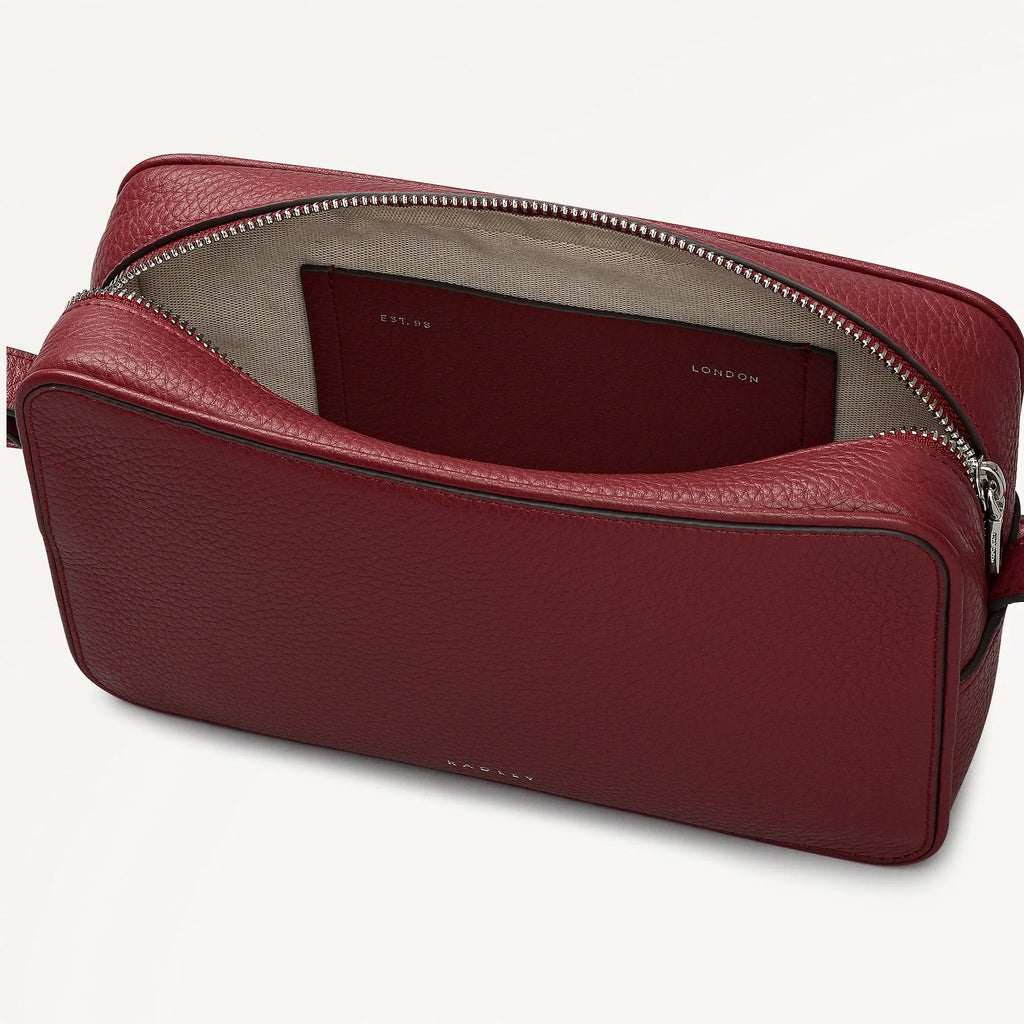 Red leather bag with a visible brand name on a white background