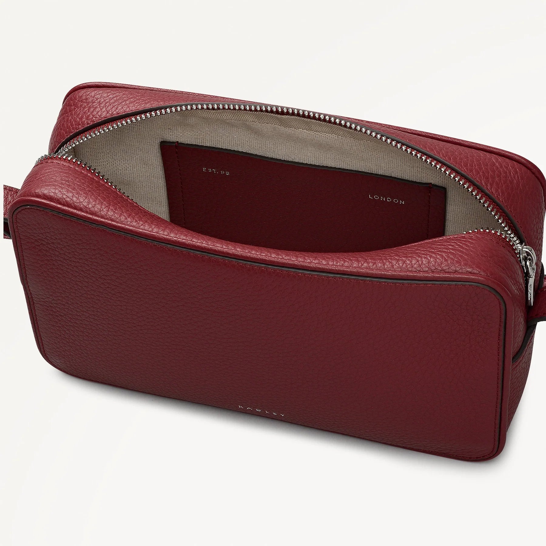 Red leather bag with a visible brand name on a white background