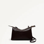 Black leather handbag on a light beige background