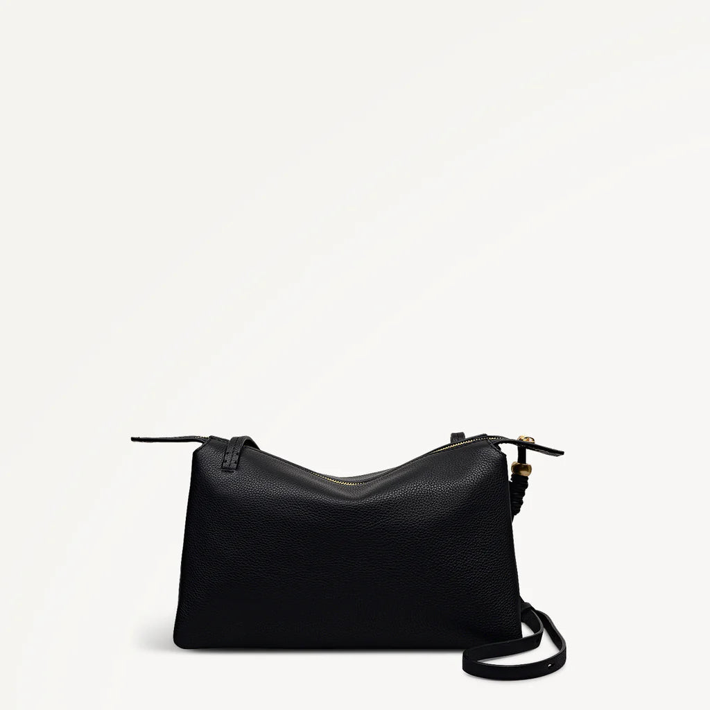 Black handbag on a light gray background