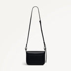 Black leather crossbody bag on a light gray background