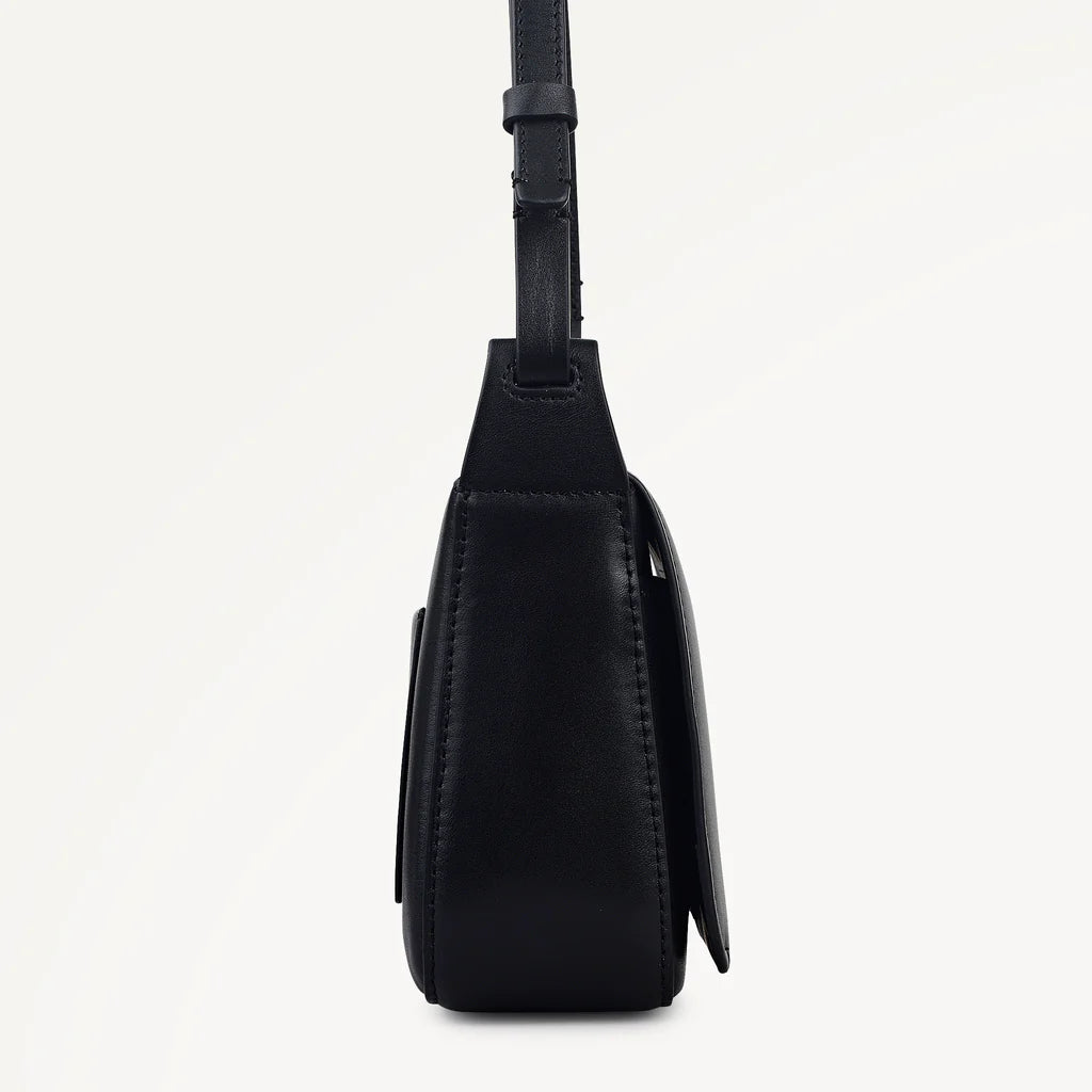 Black leather crossbody bag on a light gray background