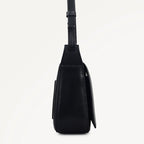 Black leather crossbody bag on a light gray background