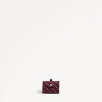 Maroon foldaway shopper folded with Radley monogram print on a light gray background