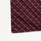 Maroon foldaway shopper  with Radley geometric monogram print on a light gray background