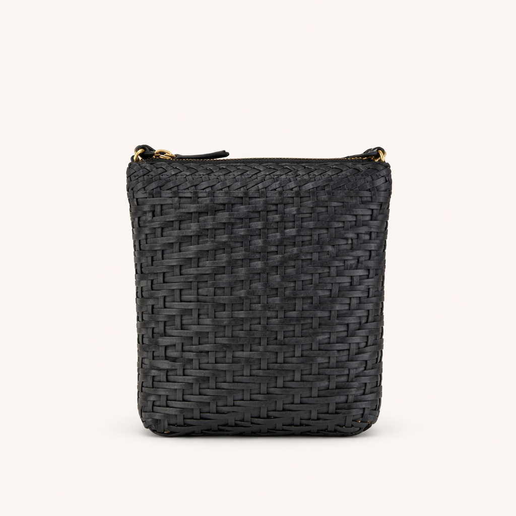 Black woven crossbody bag with a gold zipper on a white background