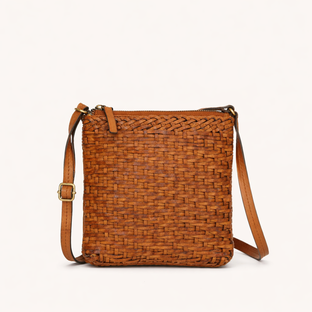 Brown woven crossbody handbag with a strap on a white background