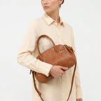 Gianni Conti Leather Bowling Bag in Brandy - carried on the arm by model
