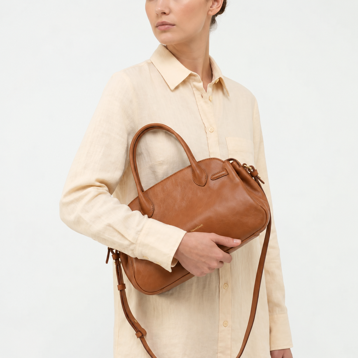 Gianni Conti Leather Bowling Bag in Brandy - carried on the arm by model