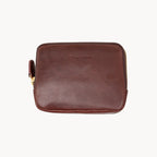 Brown leather purse with a brand name on a white background